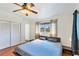 This cozy bedroom includes hardwood floors, a ceiling fan, and a closet at 4062 S Shade Ave, Sarasota, FL 34231