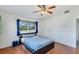 Bedroom featuring hardwood floors, a modern bed frame, and large windows at 4062 S Shade Ave, Sarasota, FL 34231