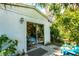 Exterior view of bonus room with glass doors, inviting natural light and lush outdoor views at 4062 S Shade Ave, Sarasota, FL 34231