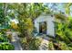 Detached bonus room with sliding glass doors and tropical plants, providing a serene retreat at 4062 S Shade Ave, Sarasota, FL 34231
