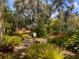 The lush garden provides a private and tranquil outdoor space with mature trees at 4062 S Shade Ave, Sarasota, FL 34231