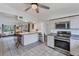 Open kitchen and dining area features stainless steel appliances, large windows and tile floors at 4062 S Shade Ave, Sarasota, FL 34231
