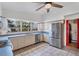 Bright kitchen features stainless steel appliances, large windows, tile floors and a ceiling fan at 4062 S Shade Ave, Sarasota, FL 34231