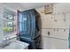 Laundry room has stacked washer and dryer, a sink, and a window providing natural light at 4062 S Shade Ave, Sarasota, FL 34231