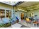 Covered patio featuring tile flooring, a dining area, comfortable seating, and views of the yard at 4062 S Shade Ave, Sarasota, FL 34231