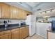 Cozy kitchen with wooden cabinets, tile flooring, and a pass-through to the living area at 4218 Heron Way # 311, Bradenton, FL 34205