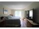 Comfortable bedroom with a large window, wood floors, and ample storage space at 425 30Th W Ave # C210, Bradenton, FL 34205