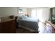 Bedroom with a comfortable bed, wooden furniture, a bright window, and laminate flooring at 425 30Th W Ave # C210, Bradenton, FL 34205
