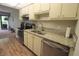 Bright kitchen with stainless steel appliances, granite countertops, tile backsplash, and wood-look flooring at 425 30Th W Ave # C210, Bradenton, FL 34205