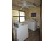 Community laundry room equipped with washing machines, dryers, and utility sink at 425 30Th W Ave # C210, Bradenton, FL 34205