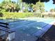 Community shuffleboard courts with surrounding benches, landscaping, and palm trees at 425 30Th W Ave # C210, Bradenton, FL 34205
