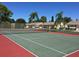 Well-maintained tennis court surrounded by lush greenery and community buildings at 425 30Th W Ave # C210, Bradenton, FL 34205