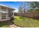 Cozy outdoor area featuring a screened lanai, artificial turf, privacy fence and brick path at 4630 56Th E Dr, Bradenton, FL 34203