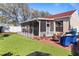 Outdoor space complete with artificial turf, brick patio, fire pit and screened in lanai at 4630 56Th E Dr, Bradenton, FL 34203