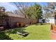 Backyard with artificial turf, dog kennels and manicured landscaping at 4630 56Th E Dr, Bradenton, FL 34203