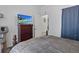 Bedroom features a cozy bed, dresser with TV, and doorway leading to another room at 4630 56Th E Dr, Bradenton, FL 34203