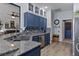 Updated kitchen with stainless steel appliances, granite countertops, and unique blue cabinetry at 4630 56Th E Dr, Bradenton, FL 34203