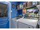 Well-organized laundry room with shelving and modern washer and dryer units at 4630 56Th E Dr, Bradenton, FL 34203