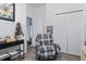 Living room featuring an armchair, table, and closet in a bright and open space at 4630 56Th E Dr, Bradenton, FL 34203