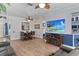 Open-concept living area with wood-look floors and a fireplace below the TV at 4630 56Th E Dr, Bradenton, FL 34203