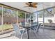 Enclosed screened patio perfect for entertaining with an outdoor table set and view of the fenced yard at 4630 56Th E Dr, Bradenton, FL 34203