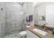 Modern bathroom featuring a walk-in shower with marble-style tiling and white vanity at 4670 Antrim Dr, Sarasota, FL 34240