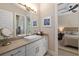 Bathroom boasting a modern sink, framed art, and view to an adjacent bedroom at 4670 Antrim Dr, Sarasota, FL 34240