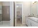 Well-lit bathroom with modern vanity and a view of the adjacent bedroom and tub at 4670 Antrim Dr, Sarasota, FL 34240