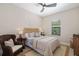 Inviting bedroom featuring a cozy chair, ceiling fan, and natural light at 4670 Antrim Dr, Sarasota, FL 34240