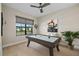 Charming bonus room with an air hockey table, window, and light wood floors at 4670 Antrim Dr, Sarasota, FL 34240