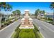 Elegant community entrance with lush landscaping and a secure gate, ensuring privacy and exclusivity at 4670 Antrim Dr, Sarasota, FL 34240