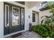 Elegant front entry featuring a decorative wreath, modern lighting, and inviting details at 4670 Antrim Dr, Sarasota, FL 34240