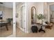 Hallway leading to another room, with a decorative mirror and wood floors at 4670 Antrim Dr, Sarasota, FL 34240