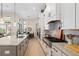 Open kitchen area with white cabinets, stainless appliances, and center island at 4670 Antrim Dr, Sarasota, FL 34240
