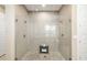 Spacious glass shower with dual shower heads and decorative tile flooring, perfect for a spa-like experience at 4670 Antrim Dr, Sarasota, FL 34240