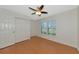 Bedroom features a ceiling fan, closet, and shuttered window at 5127 54Th W St, Bradenton, FL 34210