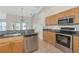 An open concept kitchen features stainless appliances and granite counters at 5127 54Th W St, Bradenton, FL 34210