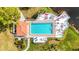 Aerial photo of large rectangular pool, deck with lounge chairs and umbrellas, and small covered building at 5187 Lake Village Dr # 4, Sarasota, FL 34235