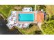 Aerial photo of large rectangular pool, deck with lounge chairs and umbrellas, and small covered building at 5187 Lake Village Dr # 4, Sarasota, FL 34235