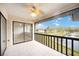 Relaxing covered outdoor patio with tile flooring, ceiling fan, and views of the pond at 5187 Lake Village Dr # 4, Sarasota, FL 34235
