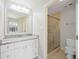 Bright bathroom featuring a granite vanity and framed shower with glass doors at 5187 Lake Village Dr # 4, Sarasota, FL 34235