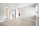 Neutral bedroom featuring tile floors, a ceiling fan, a window, and access to the ensuite bathroom at 5187 Lake Village Dr # 4, Sarasota, FL 34235