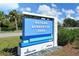 Community sign for Nathan Benderson Park with lush landscaping and a clear blue sky at 5187 Lake Village Dr # 4, Sarasota, FL 34235