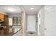 Bright condo hallway with tile flooring, modern lighting, and convenient access to multiple rooms at 5187 Lake Village Dr # 4, Sarasota, FL 34235