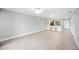 Large living room featuring a gray wall, tile floors, and bar stool seating to the kitchen at 5187 Lake Village Dr # 4, Sarasota, FL 34235