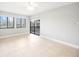 Bright living room featuring neutral paint, tile floors, a ceiling fan, and sliding door access to the lanai at 5187 Lake Village Dr # 4, Sarasota, FL 34235