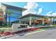 Upscale shopping center with modern architecture and lush landscaping with palm trees at 5187 Lake Village Dr # 4, Sarasota, FL 34235