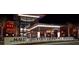 Shopping center at night featuring The Cheesecake Factory with outdoor illumination and landscaping at 5187 Lake Village Dr # 4, Sarasota, FL 34235