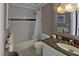 Bathroom featuring tiled shower, granite countertop vanity, and a decorative mirror at 5611 Gulf Of Mexico Dr # 5, Longboat Key, FL 34228