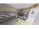 Bedroom with tile flooring, two sets of bunk beds, and nautical decor at 5611 Gulf Of Mexico Dr # 5, Longboat Key, FL 34228